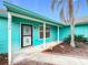 Inviting entrance with a security door and quaint landscaping, offering a welcoming first impression at 2558 Academy Ave, Deltona, FL 32738