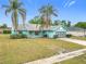 Quaint single-story home featuring a gray roof, turquoise siding, and driveway, set against a clear blue sky at 2558 Academy Ave, Deltona, FL 32738