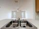 Kitchen sink view to large living area with ceiling fan at 2558 Academy Ave, Deltona, FL 32738