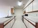 Well-lit kitchen featuring white cabinets, appliances, and ample countertop space at 2558 Academy Ave, Deltona, FL 32738