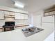 Spacious kitchen featuring a double sink and access to other rooms at 2558 Academy Ave, Deltona, FL 32738