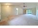 Open-plan living room featuring vaulted ceiling, closet, and slider to an enclosed porch at 2558 Academy Ave, Deltona, FL 32738