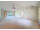 Spacious living room with vaulted ceiling and sliding glass doors to the outside, ideal for relaxation at 2558 Academy Ave, Deltona, FL 32738