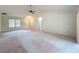 Bright and airy living room with views of the front door, enhanced by large windows and easy access to kitchen at 2558 Academy Ave, Deltona, FL 32738