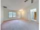 Inviting front living room with views of the entrance, featuring a closet and a large window at 2558 Academy Ave, Deltona, FL 32738