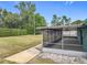 Enclosed patio space complete with ceiling fan and views of the lush, landscaped backyard at 2558 Academy Ave, Deltona, FL 32738