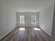 Bright bedroom featuring beautiful wood-look floors and natural light streaming through the windows at 2644 Sw 162 Nd Street Rd, Ocala, FL 34473