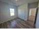 Comfortable bedroom with wood-look floors, closet, and a window bringing natural light at 2644 Sw 162 Nd Street Rd, Ocala, FL 34473