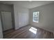 Bright bedroom features wood-look flooring, closet, and a window with a pleasant outdoor view at 2644 Sw 162 Nd Street Rd, Ocala, FL 34473