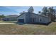 Charming single-story home with a modern architectural design and a blue garage door at 2644 Sw 162 Nd Street Rd, Ocala, FL 34473