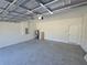 Garage space featuring concrete floors, white walls, and access door at 2644 Sw 162 Nd Street Rd, Ocala, FL 34473