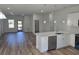 Open kitchen with stainless appliances, island and breakfast bar, and luxury vinyl plank floors at 2644 Sw 162 Nd Street Rd, Ocala, FL 34473