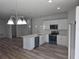 Bright kitchen with island, stainless steel appliances and stylish pendant lighting at 2644 Sw 162 Nd Street Rd, Ocala, FL 34473