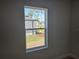 A bright window offers a lovely view of the home's exterior and landscaping at 2644 Sw 162 Nd Street Rd, Ocala, FL 34473