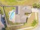 An aerial view of the property showing the pool, fenced yard, solar panels, and patio at 2844 Eagle Lake Dr, Orlando, FL 32837