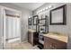 This bathroom boasts double vanities, bright lighting, and a shower with a curtain at 2844 Eagle Lake Dr, Orlando, FL 32837