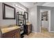 Bathroom with double sinks, granite countertops, decorative shelf and closet access at 2844 Eagle Lake Dr, Orlando, FL 32837