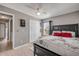 This bedroom boasts light wood floors, closet, and bright light from the lamp and window at 2844 Eagle Lake Dr, Orlando, FL 32837