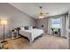 Bright bedroom with fan, decor, large window with coverings, and light wood floors at 2844 Eagle Lake Dr, Orlando, FL 32837