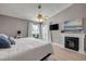 The main bedroom features a fireplace, light wood floors, decor, and bright light from the sliding glass door at 2844 Eagle Lake Dr, Orlando, FL 32837