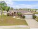 Charming one-story home featuring a manicured lawn, mature trees, and an attached two-car garage at 2844 Eagle Lake Dr, Orlando, FL 32837