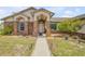 Inviting front entrance with brick accents, landscaped garden beds, and a well-lit walkway at 2844 Eagle Lake Dr, Orlando, FL 32837