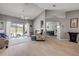 Bright living room with vaulted ceilings, hardwood floors, fireplace, and sliding doors to the backyard pool at 2844 Eagle Lake Dr, Orlando, FL 32837