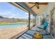 Relaxing screened lanai with seating, overlooking sparkling pool and lush backyard at 2844 Eagle Lake Dr, Orlando, FL 32837