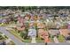 A dense residential neighborhood is shown from above, with houses that feature varied roof colors at 3192 Running Deer Path, Kissimmee, FL 34746