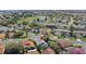 Aerial view of a residential neighborhood, showing a community with ponds and mature trees at 3192 Running Deer Path, Kissimmee, FL 34746
