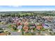 Aerial view of a residential neighborhood with lush greenery and a golf course in the background at 3192 Running Deer Path, Kissimmee, FL 34746