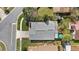 Overhead view displaying the house's gray roof, landscaping, and driveway in the neighborhood at 3192 Running Deer Path, Kissimmee, FL 34746