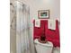 Compact bathroom with a shower/tub and decorative towels hung near the toilet at 3192 Running Deer Path, Kissimmee, FL 34746