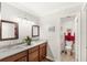Bright bathroom showcasing double sinks, granite countertops, and a separate toilet area for added convenience at 3192 Running Deer Path, Kissimmee, FL 34746
