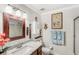 This bathroom boasts a granite countertop, framed mirror and shower for a clean and pleasant experience at 3192 Running Deer Path, Kissimmee, FL 34746