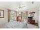 Bright bedroom featuring two windows, neutral walls, and a ceiling fan for a cozy and inviting atmosphere at 3192 Running Deer Path, Kissimmee, FL 34746