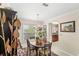 Charming dining room featuring chandelier lighting, hardwood table and decor with a view of kitchen at 3192 Running Deer Path, Kissimmee, FL 34746