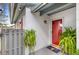 Inviting front entrance featuring a red door, textured walls, and decorative plants at 3192 Running Deer Path, Kissimmee, FL 34746
