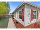 Charming home featuring bright red shutters, white stucco, and well-maintained landscaping at 3192 Running Deer Path, Kissimmee, FL 34746