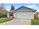 Charming single-story home with a two-car garage, red shutters, and well-manicured front lawn at 3192 Running Deer Path, Kissimmee, FL 34746