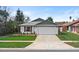 Charming single-story home with a two-car garage, red shutters, and well-manicured front lawn at 3192 Running Deer Path, Kissimmee, FL 34746