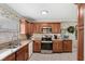 Functional kitchen featuring granite countertops, stainless steel appliances and a bright window over the sink at 3192 Running Deer Path, Kissimmee, FL 34746