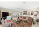 Spacious living room with plush seating, a ceiling fan, and plenty of natural light for comfortable living at 3192 Running Deer Path, Kissimmee, FL 34746