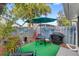 Landscaped backyard patio featuring an outdoor cooking area, plenty of room for seating, and a decorative fence at 3192 Running Deer Path, Kissimmee, FL 34746