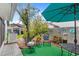 Back patio featuring cozy seating, manicured landscaping, shade trees, and a garden shed at 3192 Running Deer Path, Kissimmee, FL 34746
