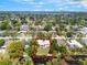 Expansive aerial view of the property surrounded by lush greenery and waterway in a beautiful neighborhood at 3204 Tradewinds Trl, Orlando, FL 32805