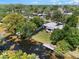 Aerial view of a waterfront home showcases its lush landscaping and access to the tranquil water at 3204 Tradewinds Trl, Orlando, FL 32805