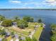 An aerial perspective of a serene property with lake access, offering tranquil living with stunning views of the water at 3204 Tradewinds Trl, Orlando, FL 32805