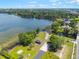 Beautiful aerial view of lakefront property with mature trees and community area at 3204 Tradewinds Trl, Orlando, FL 32805