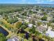 Aerial view of home that features a large backyard, a pond, and mature trees at 3204 Tradewinds Trl, Orlando, FL 32805